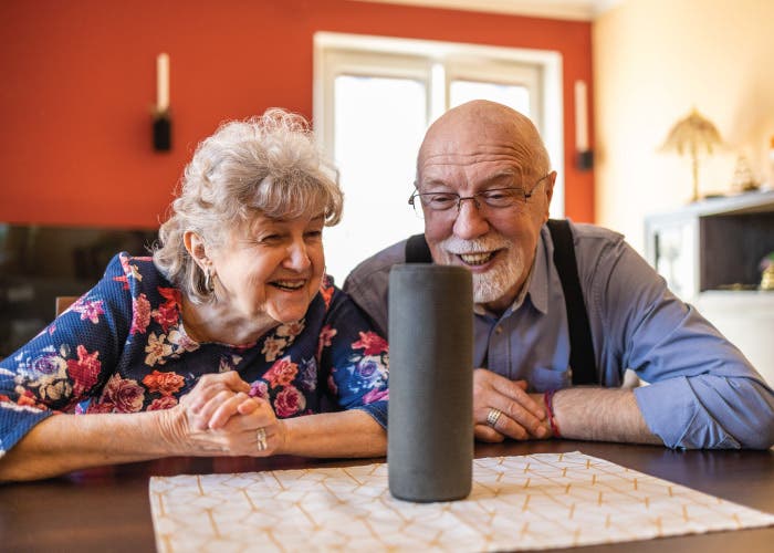 two people speaking to a smart speaker